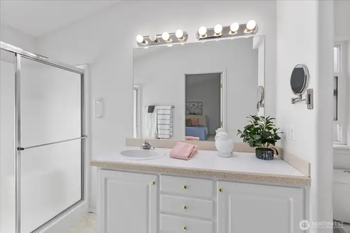 Accessible shower with grab bars and low-threshold entry.