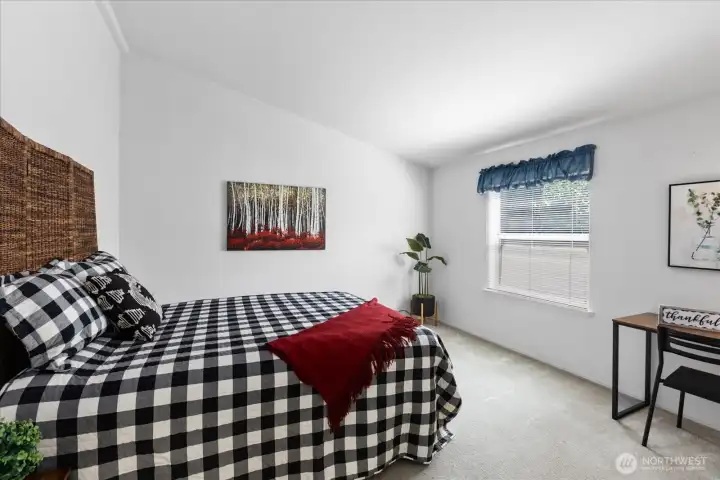 Versatile guest bedroom that serves perfectly as a craft room or a cozy secondary seating area with vaulted ceiling.
