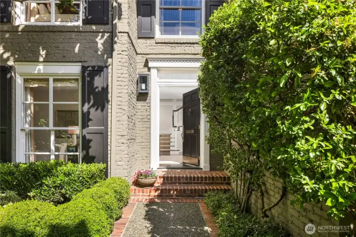 A charming brick walkway & entry framed by mature landscaping creates an elegant arrival A charming brick walkway & entry framed by mature landscaping creates an elegant arrival