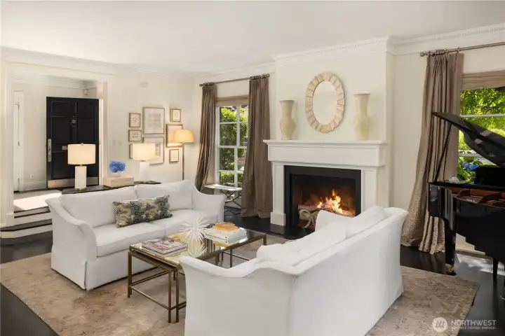 The spacious living room offers a cozy fireplace, oversized windows, and seamless flow for everyday living and entertaining. The spacious living room offers a cozy fireplace, oversized windows, and seamless flow for everyday living and entertaining.