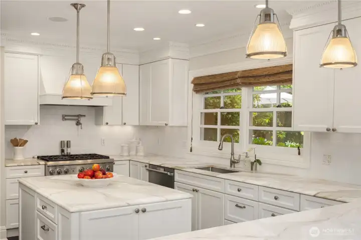 A large center island anchors the kitchen, providing the perfect space for cooking, entertaining, and casual dining. A large center island anchors the kitchen, providing the perfect space for cooking, entertaining, and casual dining.