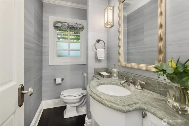 Main floor powder room, sits between the formal dining room and the kitchen. Main floor powder room, sits between the formal dining room and the kitchen.