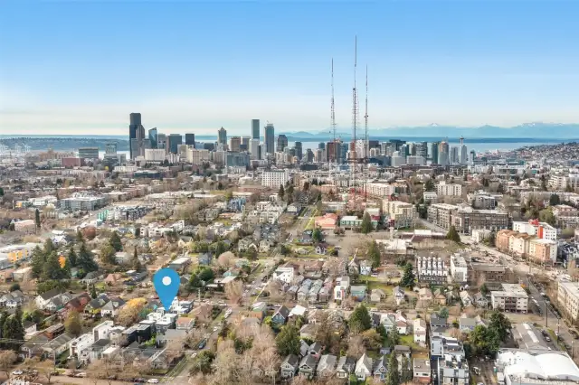 An aerial perspective that not only highlights your home's prime location but also frames the iconic Seattle skyline, showcasing the bustling city as a stunning backdrop