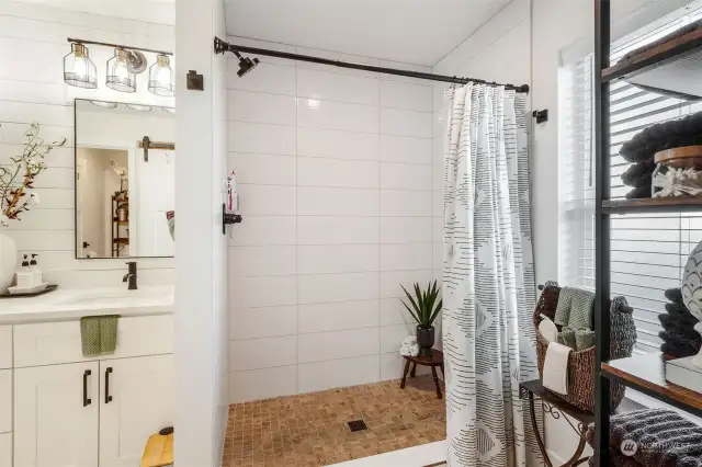 Fully tiled walk-in shower in Primary bathroom