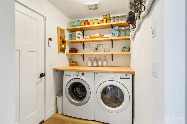 Laundry room with built-in shelves and custom folding table