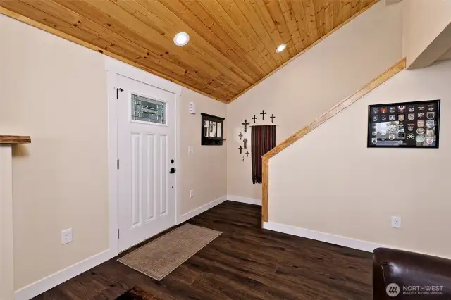 Main entry and stairway to loft bedroom with view and half bath.