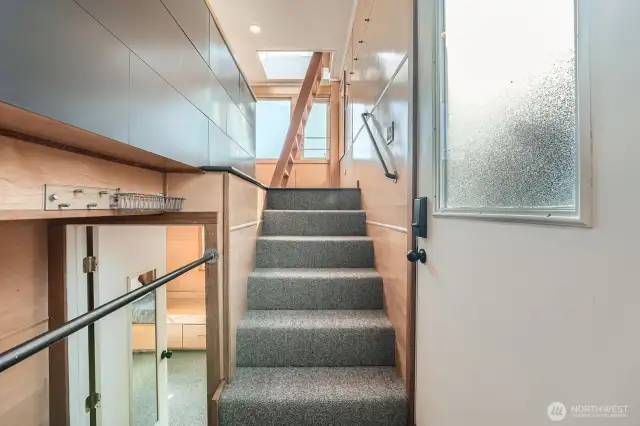 Enter in the mid to lower section of the houseboat with six steps or two steps to the lower level living spaces.