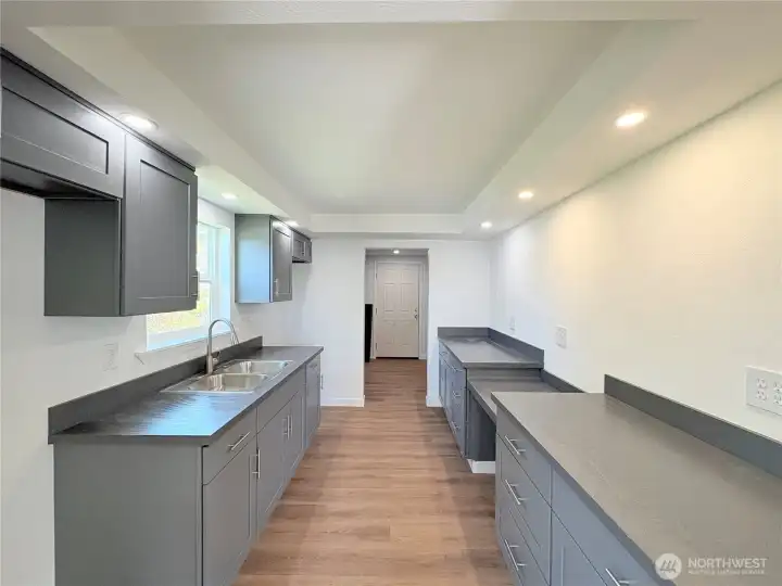 Kitchen with plenty of counter tops and cabinets for storage.