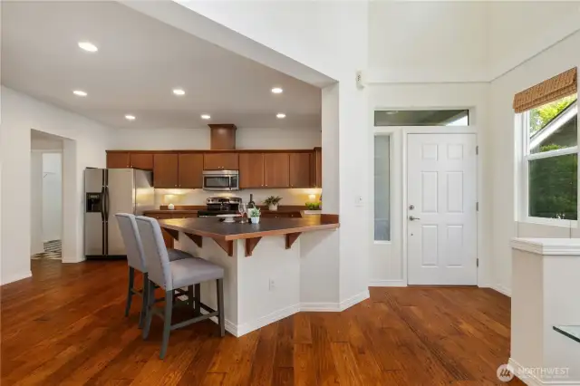 Kitchen centered between main entrance and garage entrance