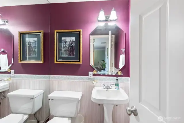 Guest bath with a full wall mirror reflexing back.