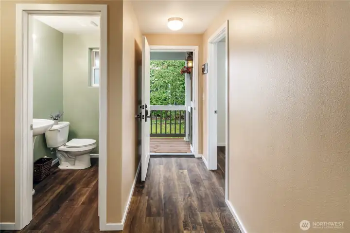 Entry & 1/2 bath showing new flooring, trim and paint.
