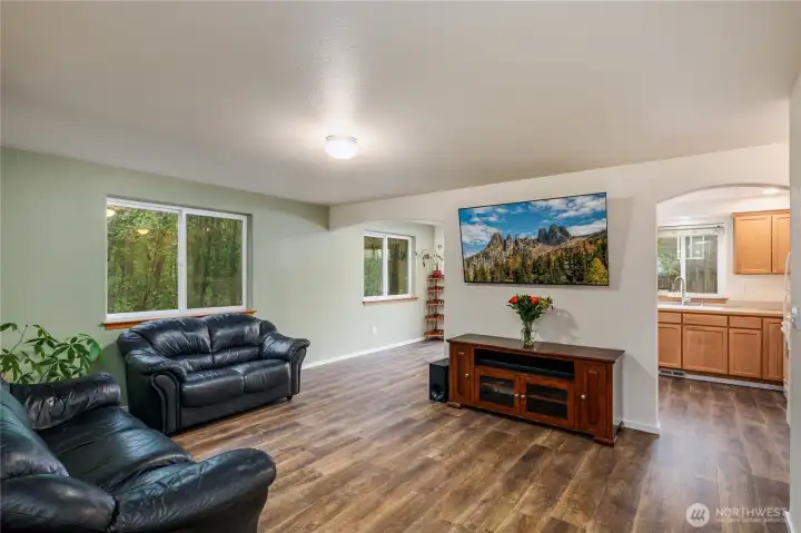 Spacious living room with new paint and flooring.