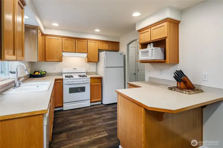 Kitchen has new flooring & oak cabinetry.