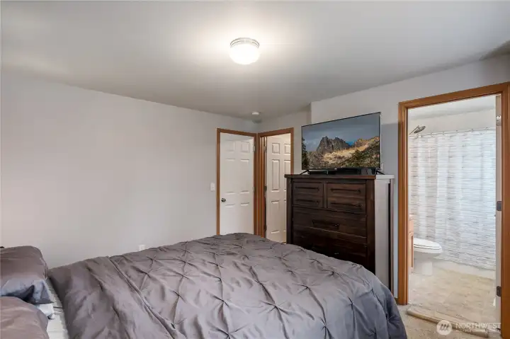 Primary bedroom showing walk in closet and full bathroom.