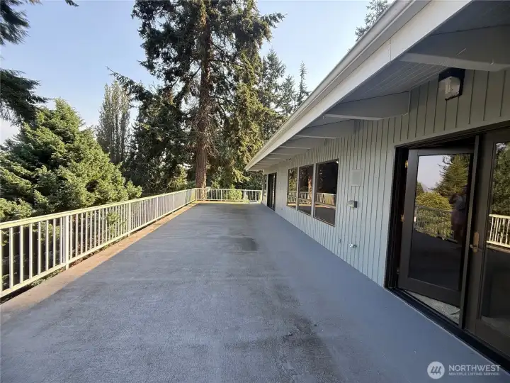 deck attached to kitchen, primary bedroom, and living room