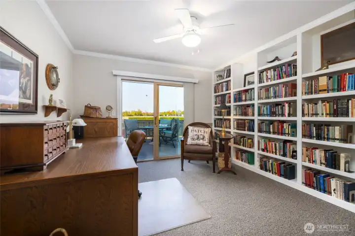 Bedroom 3 with access to back deck, built in book shelves.