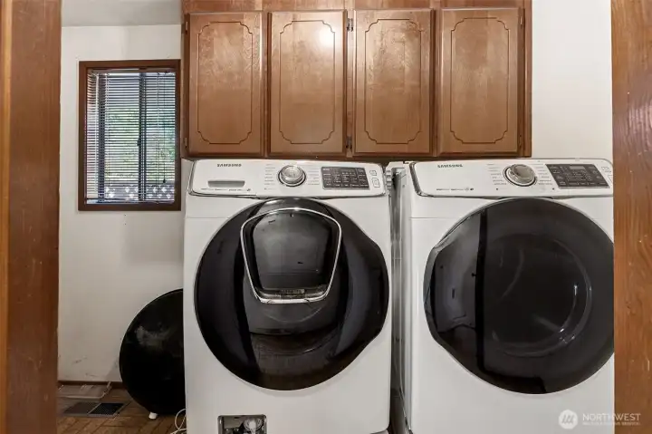 Utility room with included washer and dryer & great storage.