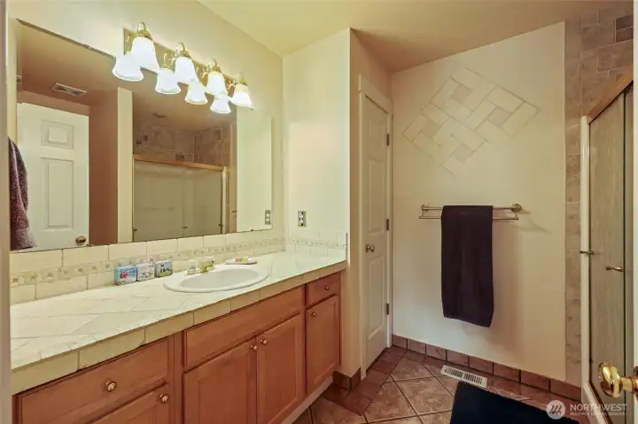 Large primary bath with linen closet, extra large vanity, commode, and oversize walk-in shower!
