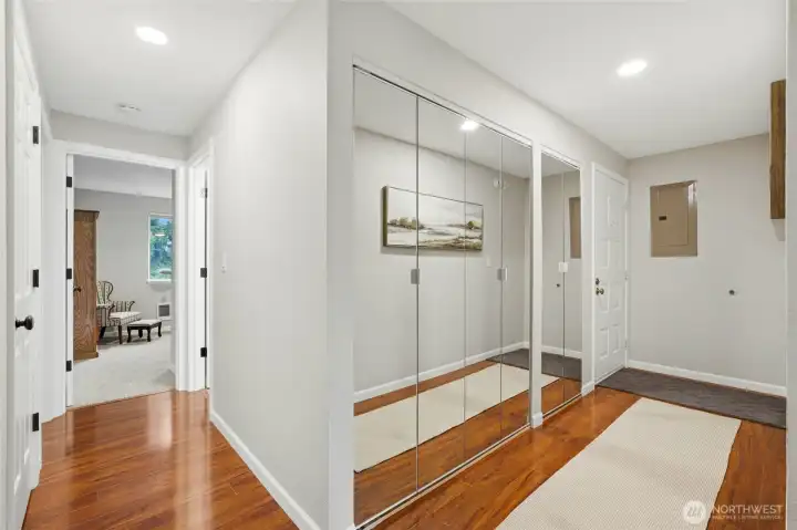 hallway to front door and hallway to bedrooms. washer and dryer are in the glass door closets