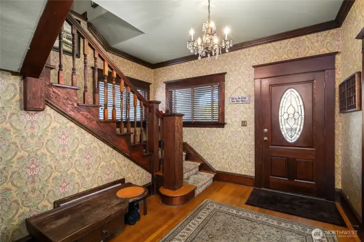 Spacious entry, original wood floors and wide staircase...