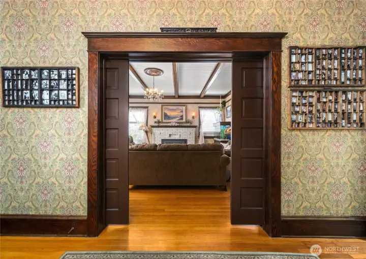 Sliding doors separate the entry of the living room...exquisite woodwork throughout...