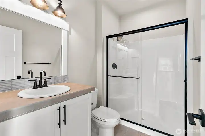 main floor 3/4 bath - photos of another Plan 2665 built at a different Harbour Homes community. Details will vary.
