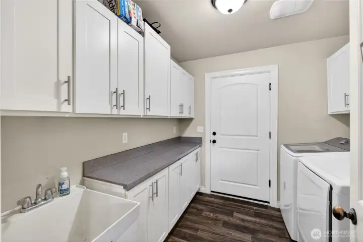 Laundry room with entrance to the attached garage.