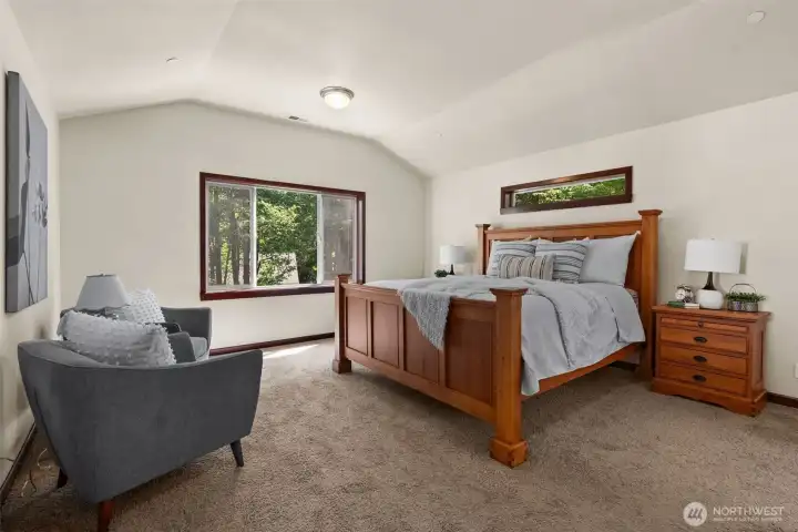Primary bedroom with vaulted ceilings