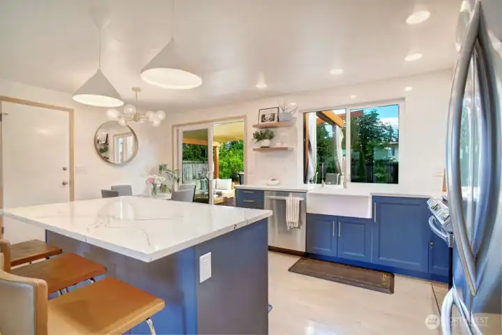 Designer cabinets and 3 seat island is a great space to have your morning coffee or quick meal