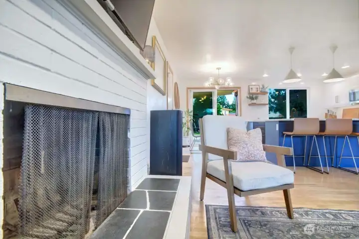 Cozy woodburning fireplace with slate base provides charm and warmth