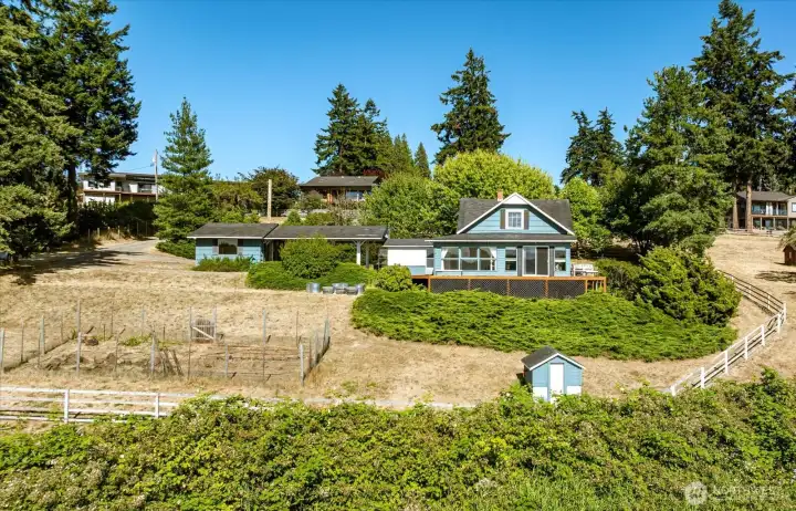 Note the large, deer-fenced garden area on the left. The studio is in the middle left, carport adjacent, then the house. The home is surrounded by 2 large pastures, one behind the home, one to the right of the fencing you see here. The upper property line is approx 318.51'. Note the large, deer-fenced garden area on the left. The studio is in the middle left, carport adjacent, then the house. The home is surrounded by 2 large pastures, one behind the home, one to the right of the fencing you see here. The upper property line is approx 318.51'.
