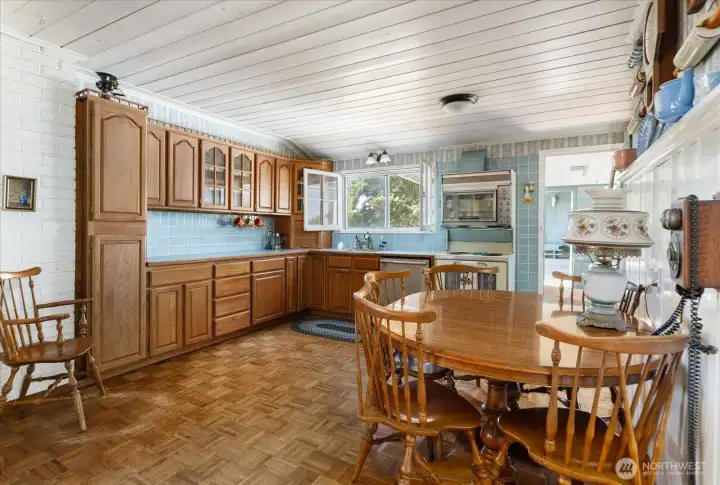 A country kitchen complete with eating space and a cozy wood stove. A country kitchen complete with eating space and a cozy wood stove.