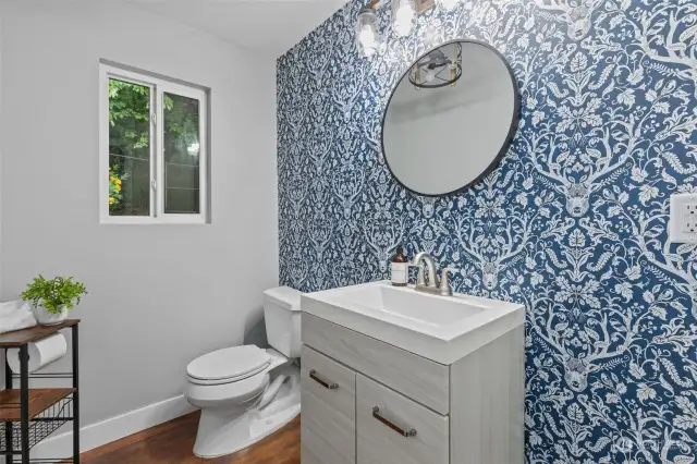this half bath was just remodeled with a fun wallpaper!