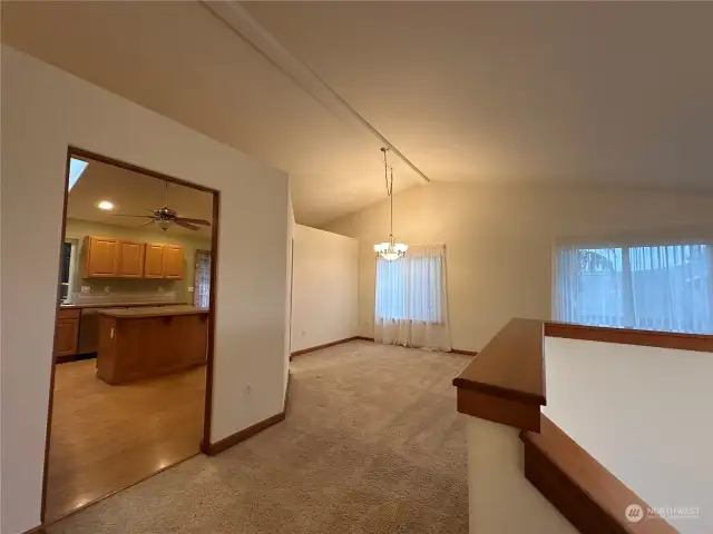 Main living room at top of entry, opens up to access to kitchen, livingroom and formal dining.