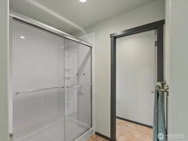 Extended Bath Fitter brand shower to right of tub. Doorway to toilet rm.