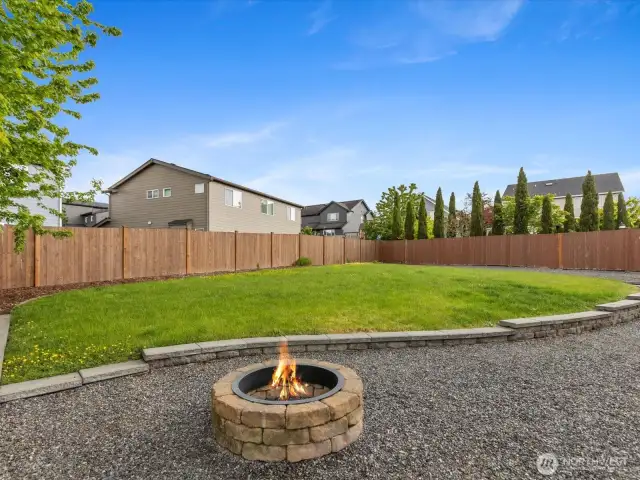 Cozy fire pit. Think of all the fun lawn games possible in this yard!