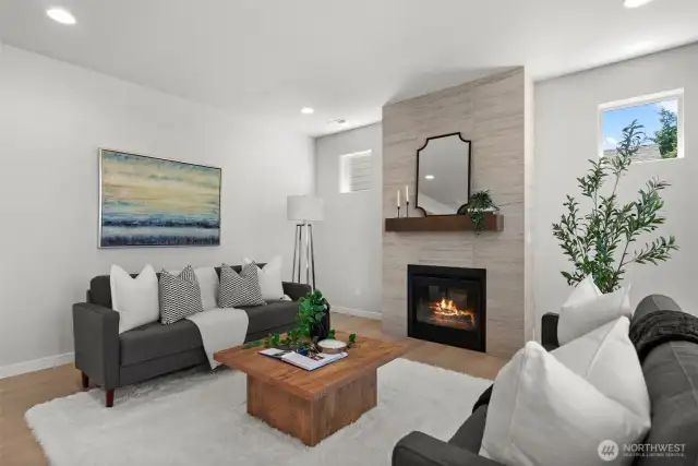 A floor to ceiling tiled wall surrounding a gas fireplace adds a beautiful focal point to the room.