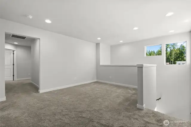 A bright spacious loft area includes ample space for a media room, office, or whatever fits your lifestyle.