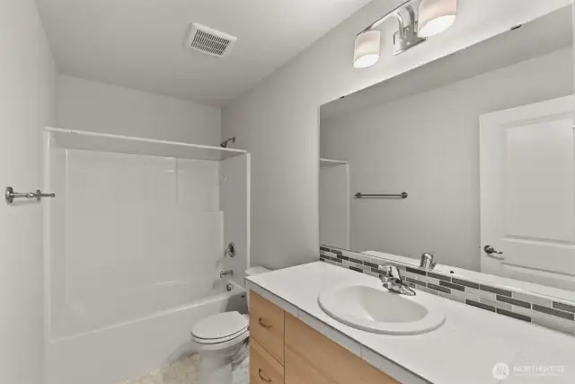 Located between the bedrooms on the upper level, the full bathroom offers convenient and easy shared access.