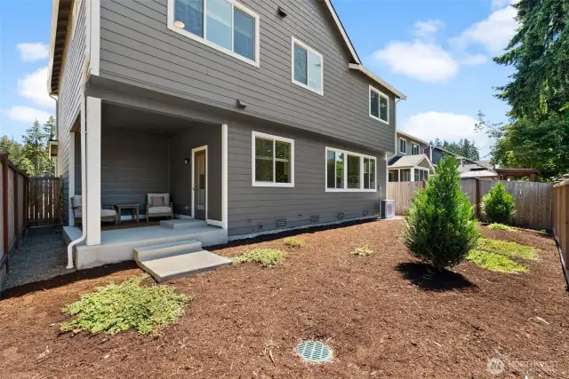 A large level backyard is fully enclosed with room for you to plant your dream garden or design a custom outdoor space.