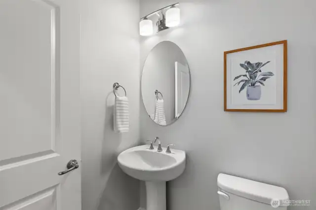Located just off the great room, the powder room offers added convenience and continues the flow of the engineered hardwood flooring.
