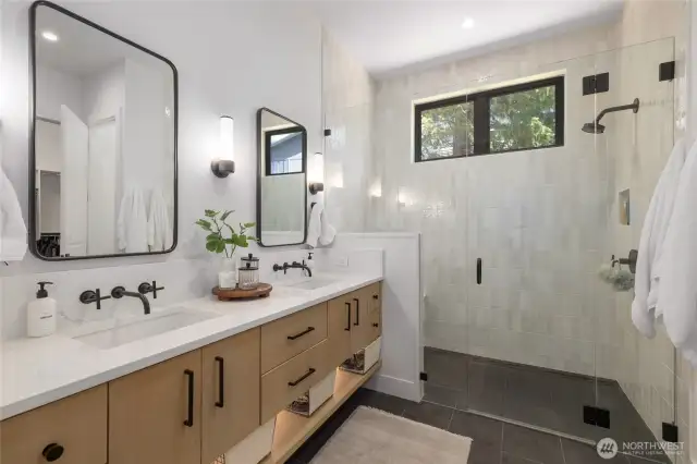 Luxurious primary bathroom w/under cabinet lighting.