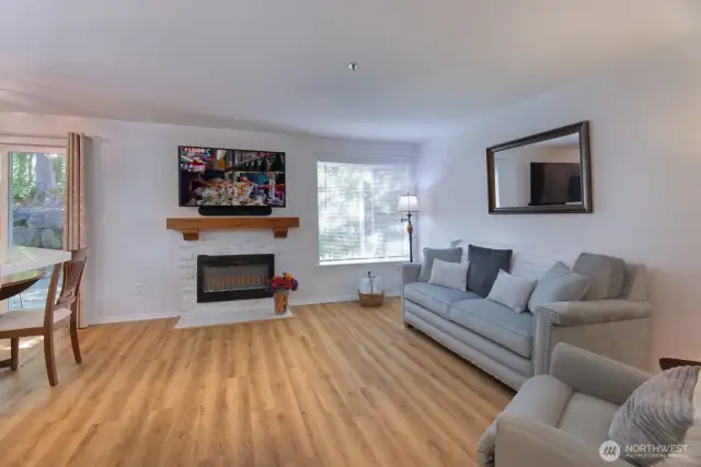 Welcome home to Carlisle Creek!  The living room features a newer electric fireplace and travertine stack stone tile installed in 2020