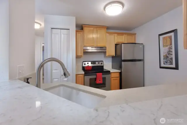Kitchen includes all appliances including a newer garbage disposal, quartz countertops, newer sink and faucet all installed in 2020