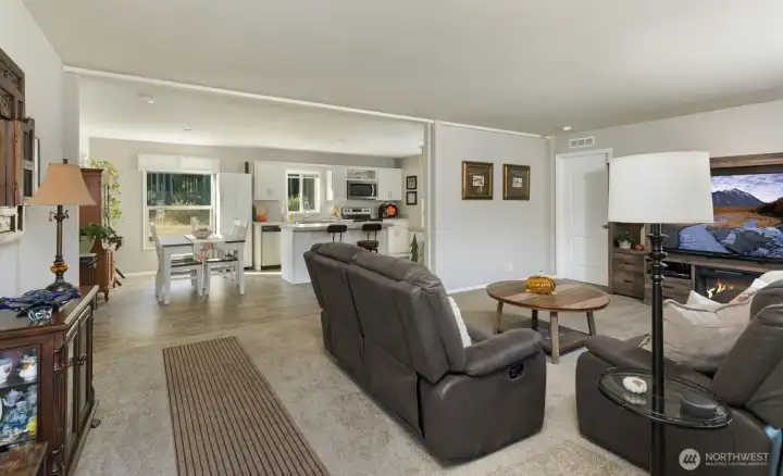 Living, dining, and kitchen areas, are seamlessly connected, creating a comfortable and functional layout for everyday living.