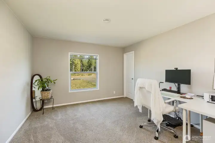 This versatile room can easily serve as a home office, gym, or guest bedroom, with plenty of natural light, neutral finishes and walk-in closet.