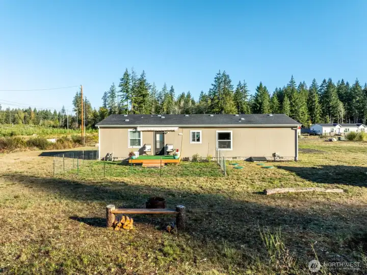 A compact fenced area ideal for pets or a starter garden, plus a firepit for gatherings.