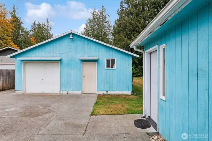 View of garage - one car w/ shop & large patio