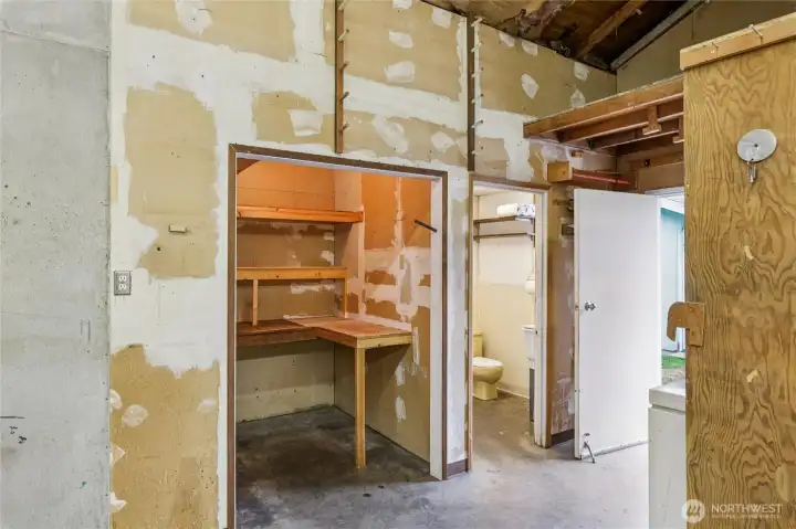 View of garage w/ storage room and 3/4 bath