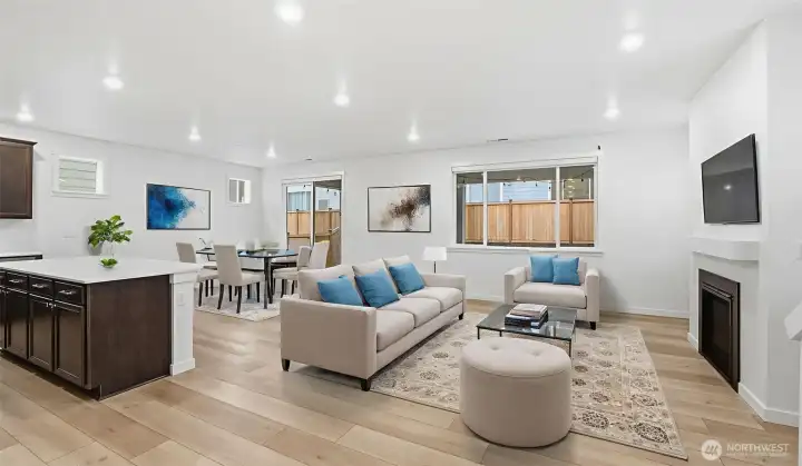 Showcased with virtual staging to illustrate spacious seating and dining arrangement potential.